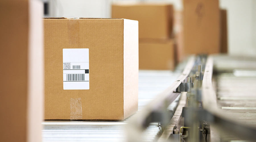 Goods On Conveyor Belt In Distribution Warehouse